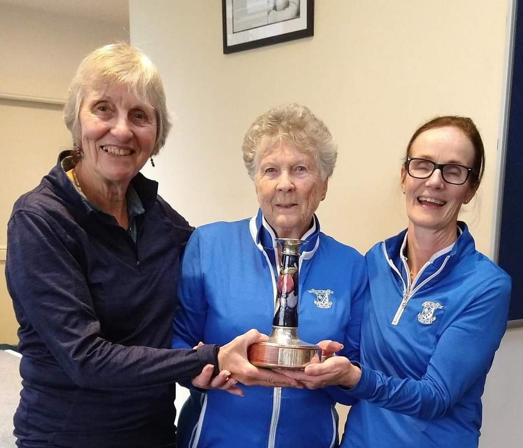 Viv Kenwright and Eleanor Walker receive the RS Matthews Trophy from Jenny Hunt (Lady Captain Elect)